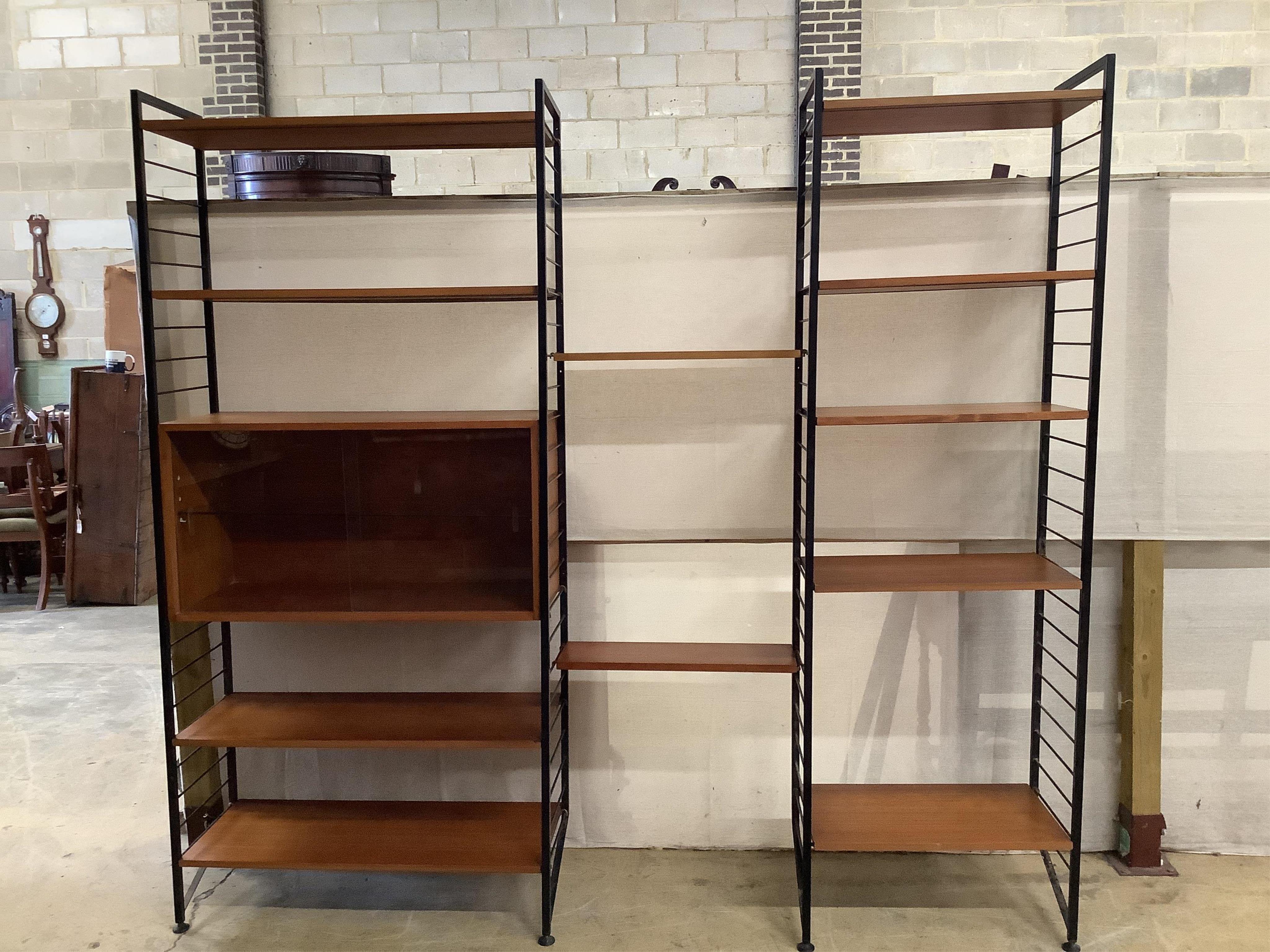 A mid century teak Ladderax shelving unit, width 215cm, depth 35cm, height 201cm. Condition - good